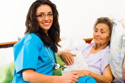 female nurse caring senior woman